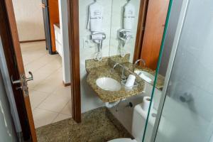 a bathroom with a sink and a shower at Diamond Beach in Vila Velha