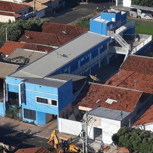 an overhead view of a blue building with red roofs at Raízes Hotel in Cajobi