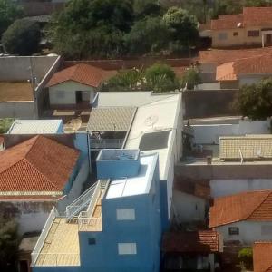 an aerial view of roofs of buildings in a city at Raízes Hotel in Cajobi