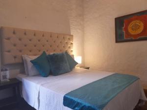A bed or beds in a room at Hotel Y Spa Santos De Piedra