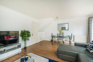 a living room with a couch and a table at Beautiful 3 Bed House with Amazing Views in Dartford, Kent in Kent