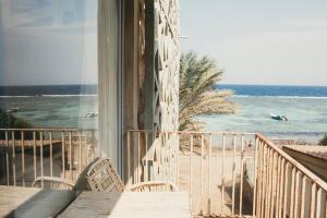 a balcony with a view of the beach and the ocean at Dar Dahab in Dahab