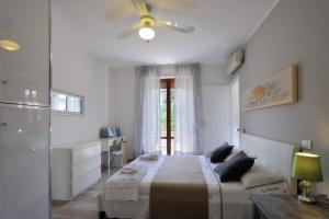 a bedroom with a bed and a ceiling fan at Casarimidia in Perugia