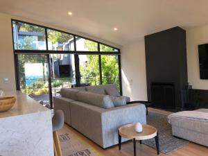 ein Wohnzimmer mit einem Sofa und einem Kamin in der Unterkunft Architect designed 4 bedroom with ocean views from every room in Lorne