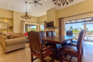 a dining room with a wooden table and chairs at Villa Gracia in Cabo San Lucas
