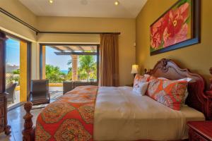 a bedroom with a bed and a large window at Villa Gracia in Cabo San Lucas
