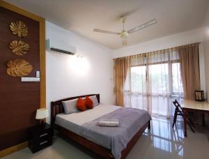 a bedroom with a bed and a large window at Sea Lion by the beach in George Town