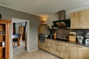 a kitchen with wooden cabinets and a counter top at Villa Meisen in Medebach