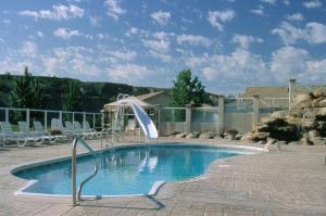 a swimming pool with a slide in a resort at Paradise Canyon Golf Resort, Signature Walkout Condo 380 in Lethbridge