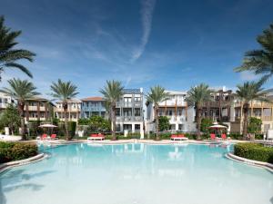 a large swimming pool with palm trees and apartments at Marlin Bay Resort & Marina Managed by Elite Alliance Hospitality in Marathon