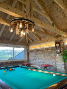 a pool table in a room with a ceiling at Vila Impresija, Fruška gora in Novi Sad