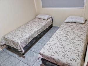 two beds sitting next to each other in a room at ITURANCH in Ituzaingó