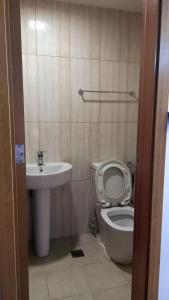 a bathroom with a toilet and a sink at JohnStay in Manila