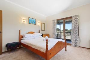 a bedroom with a bed and a balcony at Halcyon in Nungurner