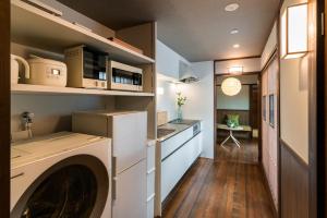 a kitchen with a washing machine in a room at Saik in Kanazawa