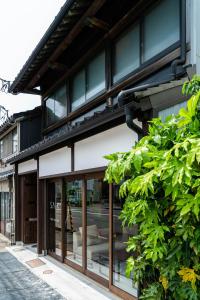 a store front with glass windows and a building at Saik in Kanazawa