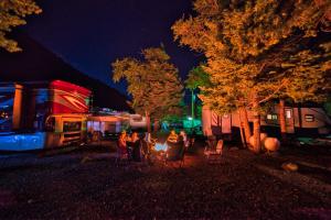 a group of people sitting around a camp site at night at Ouray Riverside Resort - Inn & Cabins in Ouray