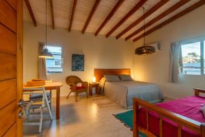 a bedroom with a bed and a desk and a table at Alma Serena in La Paloma