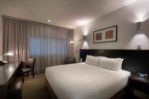 a hotel room with a large bed and two lamps at Causeway 353 Hotel in Melbourne