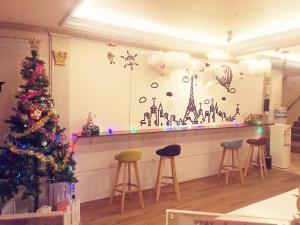 a bar with a christmas tree and stools at 友愛金色商旅Golden Age Hotel in Taipei