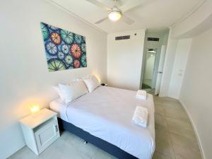 a bedroom with a bed and a painting on the wall at Sebel 302 - Deluxe Apartment in Maroochydore