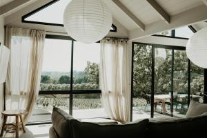 a living room with a couch and a large window at Cassis Red Hill in Red Hill