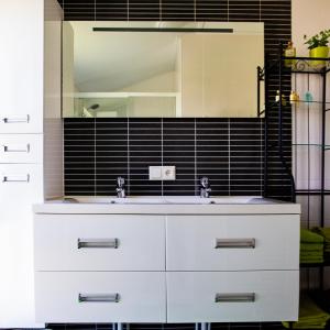 a bathroom with a white sink and a mirror at luxe cottage knokke heist in Knokke-Heist