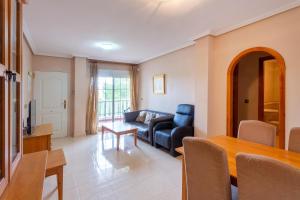 a living room with a couch and a table at Playa Golf 2 in Cabo Roig