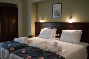 Ένα ή περισσότερα κρεβάτια σε δωμάτιο στο Ξενοδοχείο Αντωνιάδης