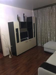 a living room with a entertainment center with a tv at 1к. Апартаменты НСК , на ул.Ватутина 24 in Novosibirsk