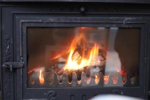 a fire in a fireplace with flames in it at Monat Otel Alaçatı in Alaçatı