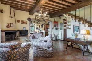 a living room with two couches and a fireplace at Villa Mila 6, Emma Villas in Gualdo Cattaneo