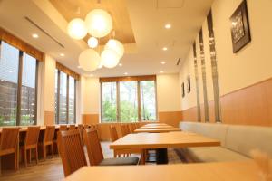 a row of tables and chairs in a restaurant at Rembrandt Style Tokyo Nishikasai Grande in Tokyo