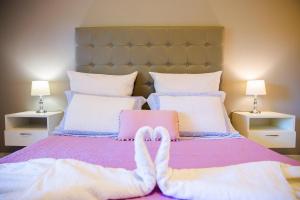 a person with their feet up on a bed at Sunset Apartments in Archangelos