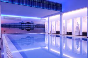 a large swimming pool in a house with a swimming pool at Hotel Sina Astor in Viareggio