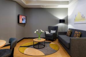 a living room filled with furniture and a tv at Citadines City Centre Tbilisi in Tbilisi City