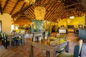 a dining room with tables and chairs in a restaurant at Gondwana Namib Desert Lodge in Solitaire