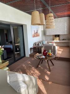 a living room with a couch and a table at Les Jardins De La Koutoubia in Marrakesh