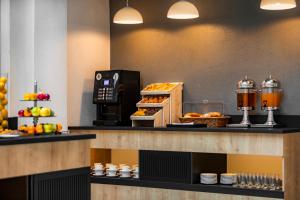 a kitchen filled with lots of different types of food at Citadines City Centre Tbilisi Apart`hotel in Tbilisi City