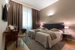 En eller flere senge i et værelse på Villaggio Narrante - Foresteria delle Vigne