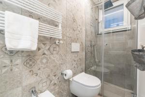 a bathroom with a toilet and a glass shower at La Perla del Mare, Terre Marine in Monterosso al Mare +10 photos