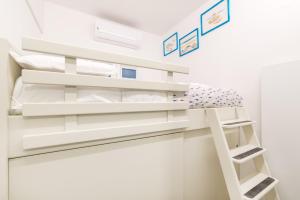 a bunk bed in a small room with white walls at La Perla del Mare, Terre Marine in Monterosso al Mare