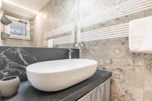 a bathroom with a white sink on a counter at La Perla del Mare, Terre Marine in Monterosso al Mare