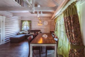 a living room with a table and a couch at Villa Kurpitsa at MESSILA ski & camping in Hollola