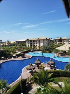 a view of a resort swimming pool with umbrellas at Vg Sun cumbuco 310 c4 in Cumbuco