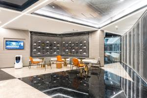 a dining room with chairs and a wall of wine bottles at Atour Hotel Shaoxing Jinghu City Hall Basketball Theme in Shaoxing