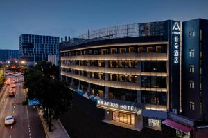 a hotel with a sign on the side of a building at Atour Hotel Hangzhou East Railway Station in Hangzhou