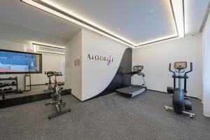 a gym with two exercise bikes and a flat screen tv at Atour Hotel Hangzhou East Railway Station in Hangzhou