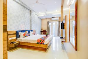 a bedroom with a large bed in a room at FabHotel 7th Crossing in Jaipur