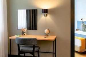 a lamp is on in the corner of a room at Citadines City Centre Tbilisi in Tbilisi City